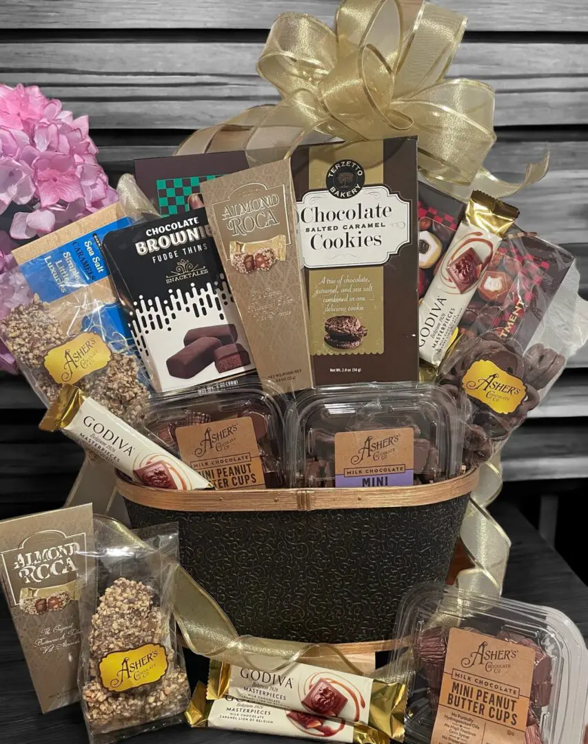A gift basket filled with assorted chocolates and cookies.