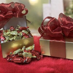 Gold boxes of chocolates, red ribbons.