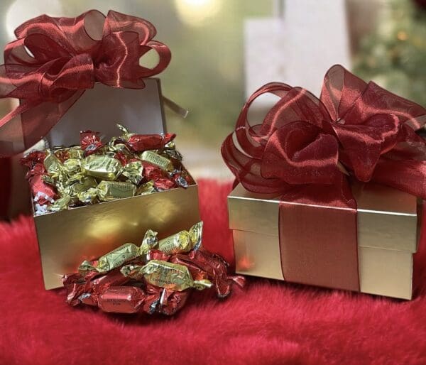 Gold boxes of chocolates, red ribbons.